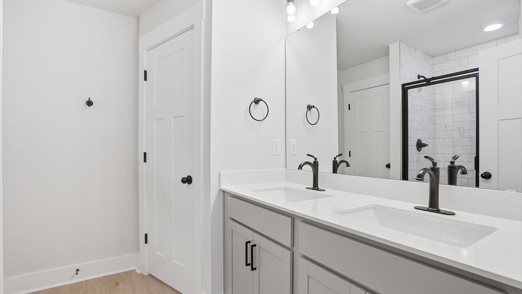 Notable primary bath featuring dual vanity, walk-in shower, and tasteful design touches throughout in Simpsonville, SC