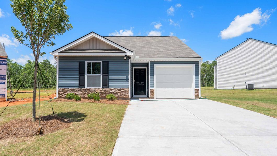Front exterior of a new home in Village Grove, Greenville, SC, highlighting curb appeal (Image 1). Front exterior of a new home in Village Grove, Greenville, SC, highlighting curb appeal (Image 1).