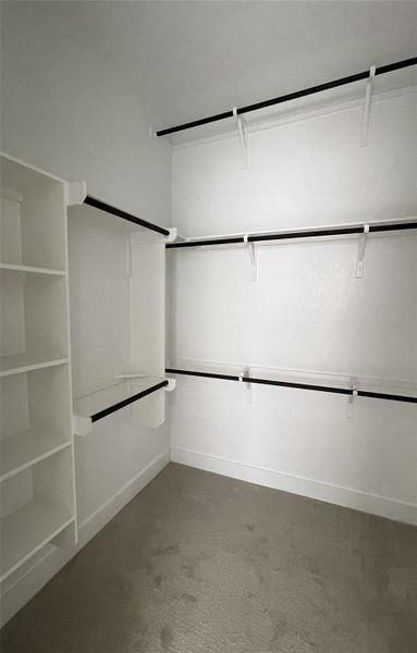 Organized closet with ample shelving and hanging rods for all your storage needs. Organized closet with ample shelving and hanging rods for all your storage needs.