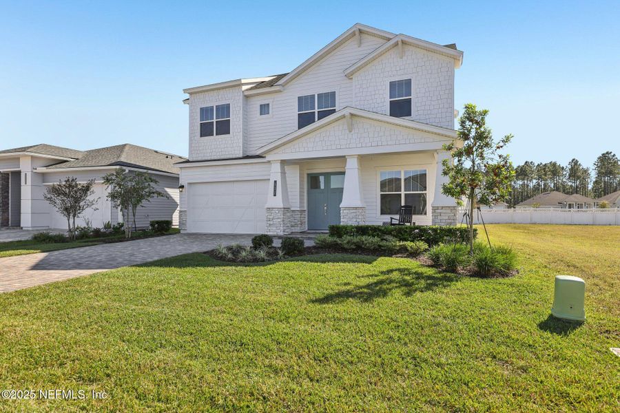 Front exterior of a new home in Courtney Chase, St. Augustine, FL, highlighting curb appeal (Image 29). Front exterior of a new home in Courtney Chase, St. Augustine, FL, highlighting curb appeal (Image 29).