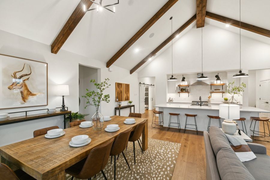 Open concept living spaces with vaulted ceiling and stained ceiling beams Open concept living spaces with vaulted ceiling and stained ceiling beams