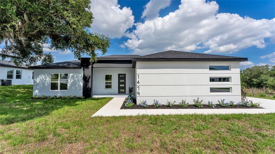 Front exterior of a new home in , Davenport, FL, highlighting curb appeal (Image 1). Front exterior of a new home in , Davenport, FL, highlighting curb appeal (Image 1).