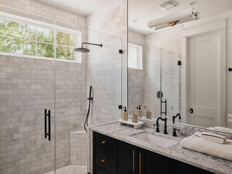 Bathroom featuring a shower stall and vanity