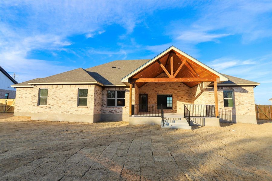 Back of property with a patio area and brick siding