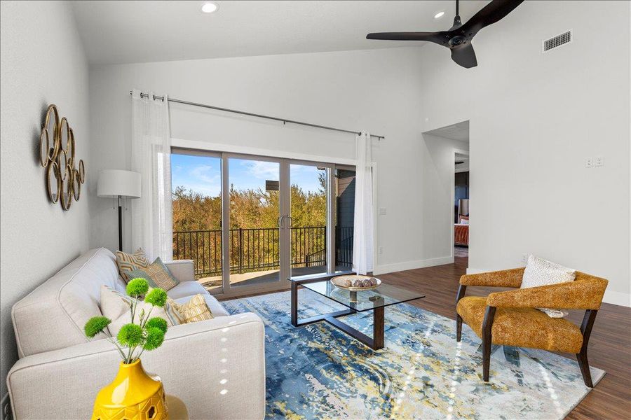Living area with wood finished floors, ceiling fan, recessed lighting, and high vaulted ceiling