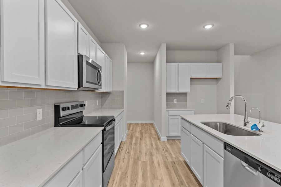 A kitchen with white cabinets. A kitchen with white cabinets.