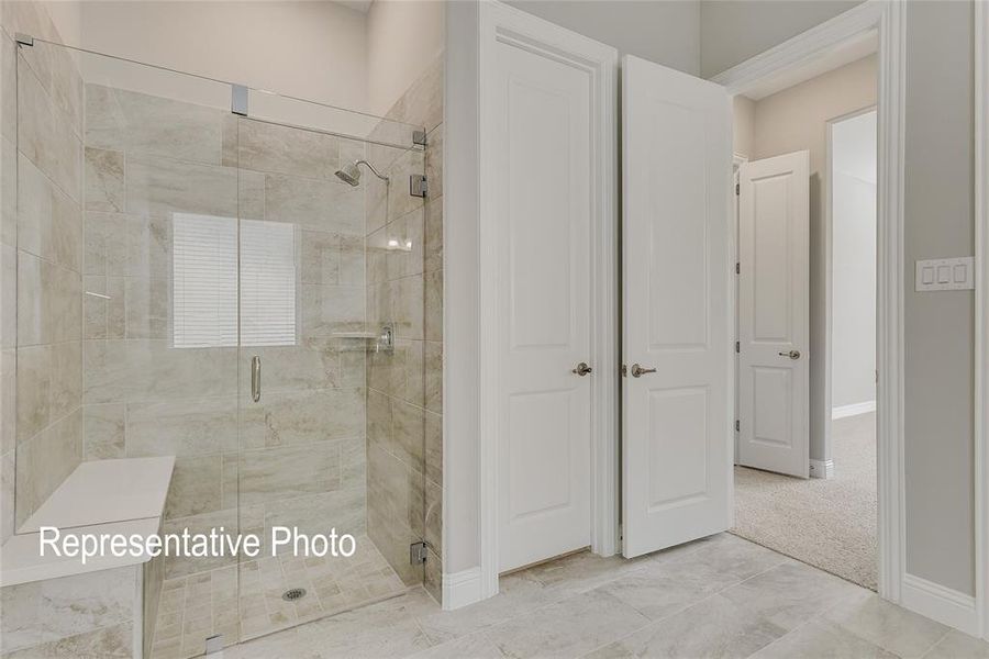 Bathroom featuring a shower with door