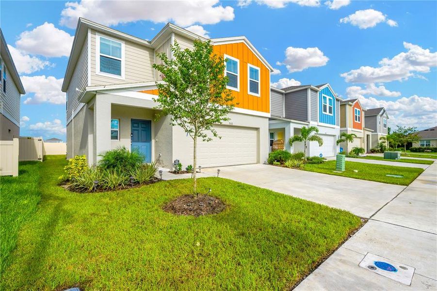 Front exterior of a new home in Pasadena Point, Wesley Chapel, FL, highlighting curb appeal (Image 1). Front exterior of a new home in Pasadena Point, Wesley Chapel, FL, highlighting curb appeal (Image 1).