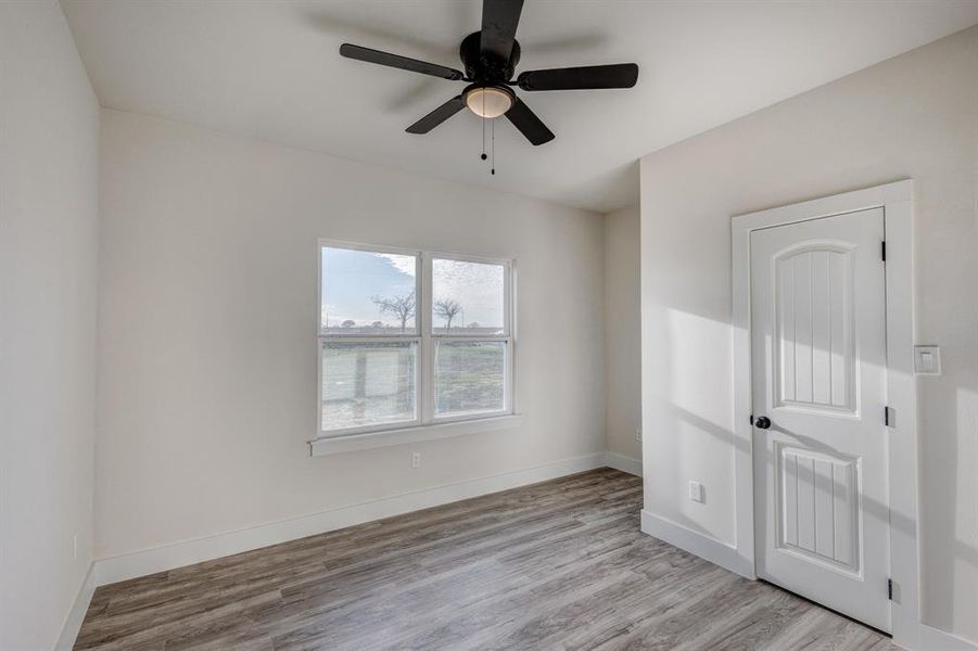 Unfurnished room featuring ceiling fan and light hardwood / wood-style floors