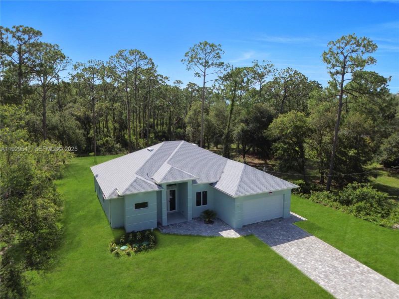 Front exterior of a new home in , Lehigh Acres, FL, highlighting curb appeal (Image 19). Front exterior of a new home in , Lehigh Acres, FL, highlighting curb appeal (Image 19).