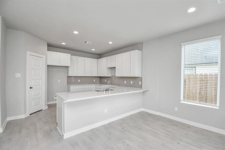 The extended counter area adds both practicality and style, making meal preparation a breeze. Every detail is thoughtfully designed to enhance the kitchen's functionality and aesthetic appeal.