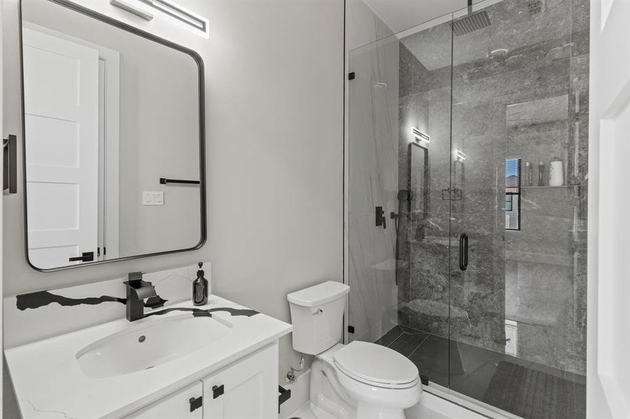 Bathroom featuring vanity and a stall shower