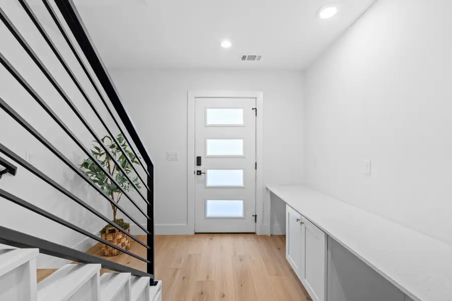 Entrance foyer with light wood-type flooring and recessed lighting