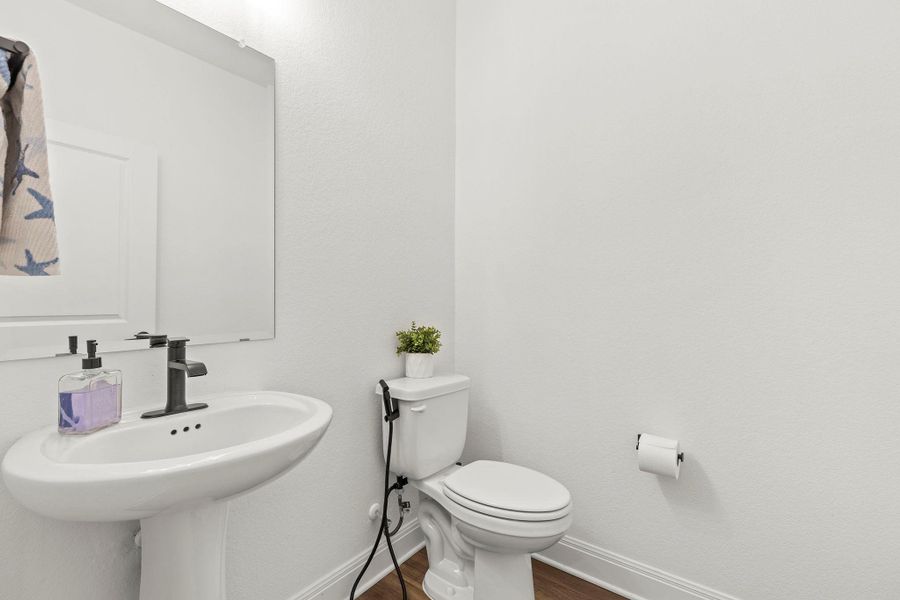 Bathroom with baseboards and dark wood finished floors