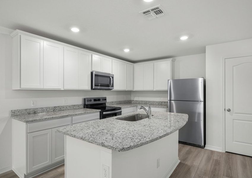 Kitchen with white cabinets, granite countertops and stainless steel appliances