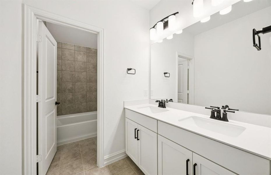 Spacious secondary bathroom with dual vanity*real home pictured