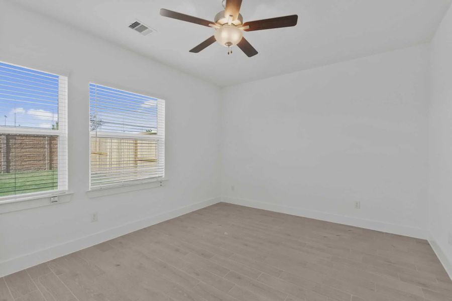 Representative unfurnished interior of a home built from the Carriagehouse by Chesmar Homes in Meridiana Townhomes, Iowa Colony (Image 94).