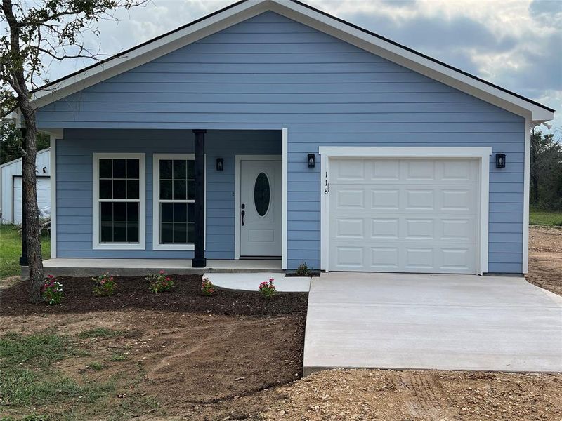 Front exterior of a new home in , Smithville, TX, highlighting curb appeal (Image 2). Front exterior of a new home in , Smithville, TX, highlighting curb appeal (Image 2).