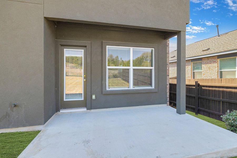 View of exterior entry with a patio and stucco siding