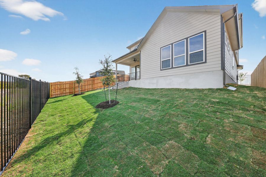 Rear view of house with a patio, a fenced backyard, and a ceiling fan Rear view of house with a patio, a fenced backyard, and a ceiling fan