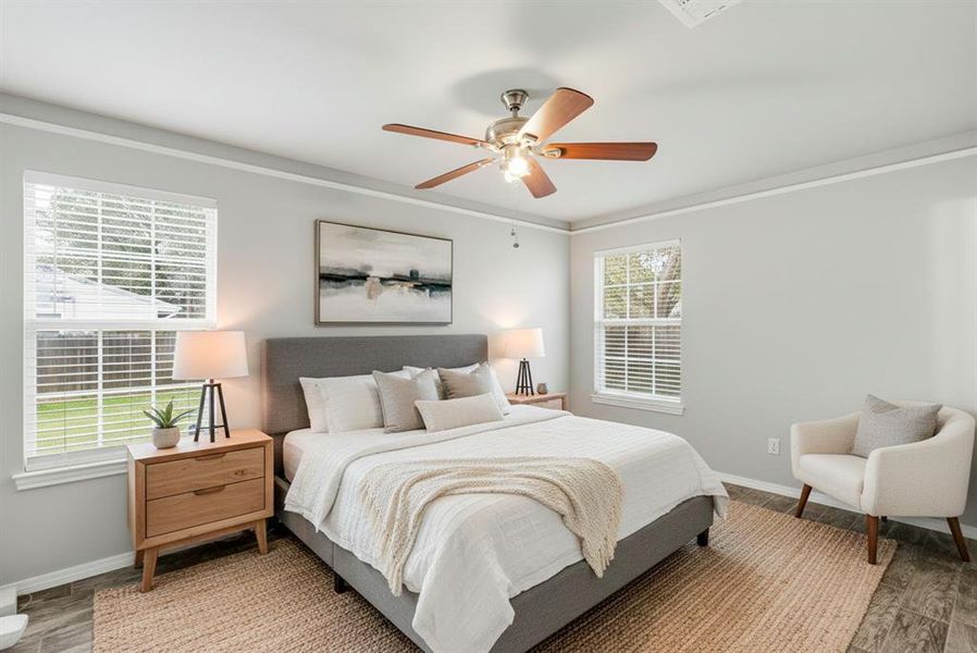 Virtually Staged Bedroom featuring wood finished floors, ceiling fan, and crown molding Virtually Staged Bedroom featuring wood finished floors, ceiling fan, and crown molding