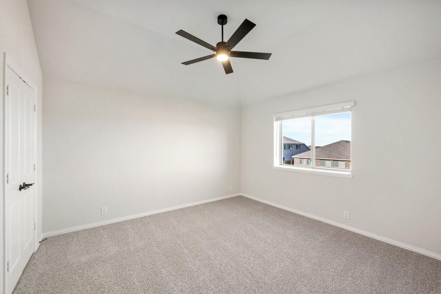 Empty bedroom with gray carpet, black ceiling fan with light, and single window Empty bedroom with gray carpet, black ceiling fan with light, and single window