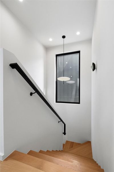 Clean lines define this staircase with modern lighting and a refined wood floor.