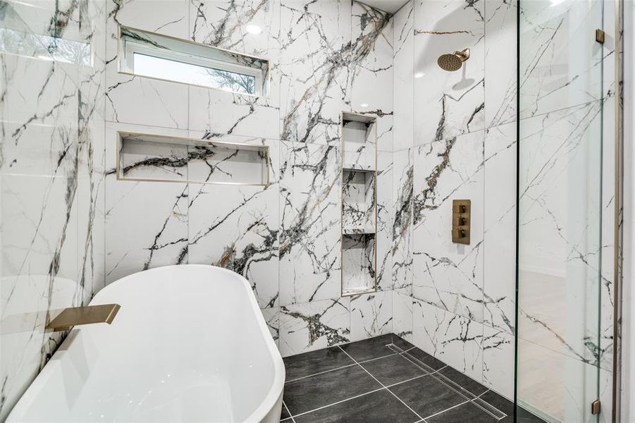 Bathroom with independent shower and bath and tile walls