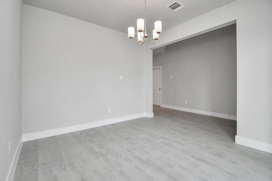 Craft enduring memories with loved ones around the table! This roomy dining area boasts stylish flooring, personalized paint, and is conveniently situated next to the family room and kitchen, fostering an open and inclusive ambiance. Sample photo of completed home with similar floor plan. Actual colors and selections may vary. Craft enduring memories with loved ones around the table! This roomy dining area boasts stylish flooring, personalized paint, and is conveniently situated next to the family room and kitchen, fostering an open and inclusive ambiance. Sample photo of completed home with similar floor plan. Actual colors and selections may vary.