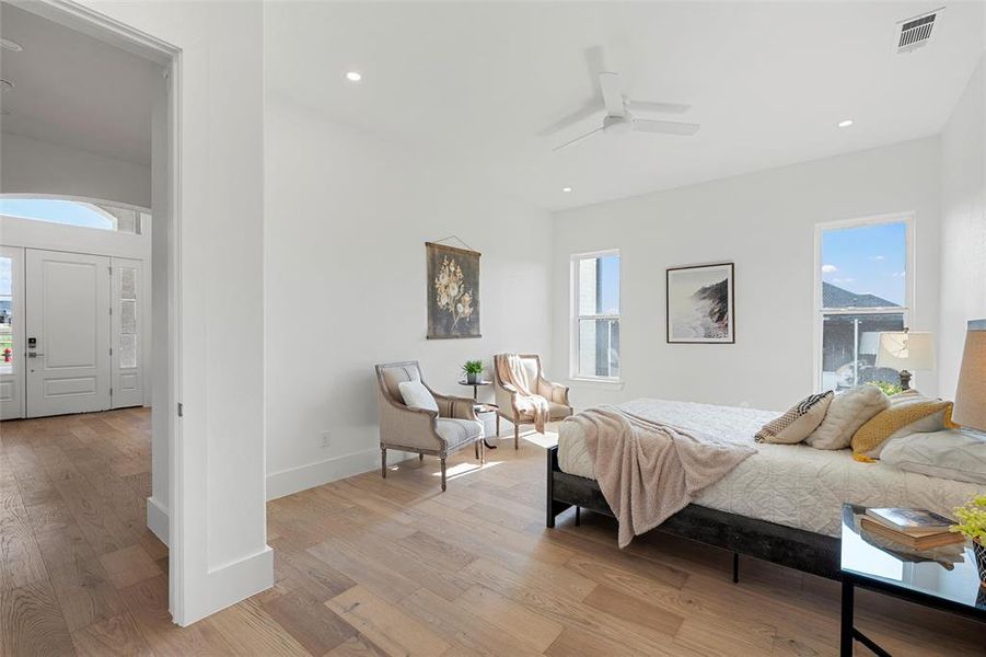 Bedroom featuring light wood-style flooring, recessed lighting, and a ceiling fan Bedroom featuring light wood-style flooring, recessed lighting, and a ceiling fan
