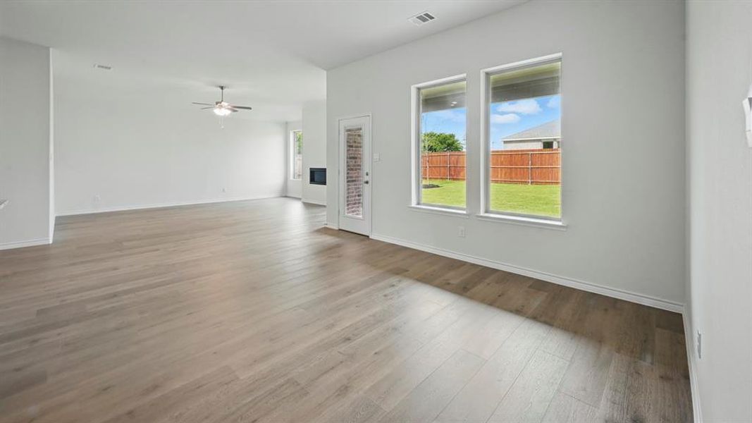Unfurnished living room with light wood finished floors and a ceiling fan