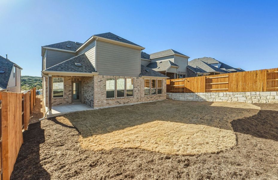 Exterior details and patio area of a home in West Cypress Hills, Spicewood (Image 26).