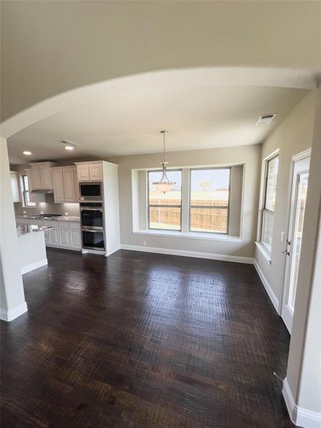 Unfurnished living room featuring dark hardwood / wood-style flooring