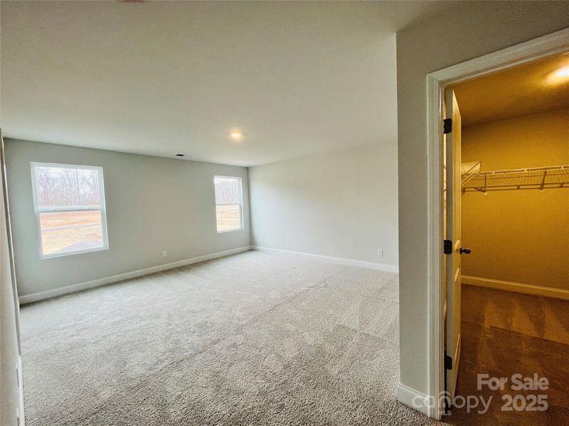Primary bedroom with a walk in closet in bedroom and another in the bathroom!