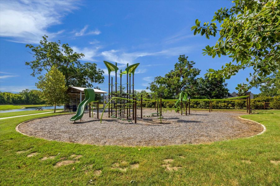 Modern playground design with climbing structures, slides, and open space to run and explore. Set beside the water with shaded seating nearby, creating an easy spot for playdates and laid back afternoons outdoors. Modern playground design with climbing structures, slides, and open space to run and explore. Set beside the water with shaded seating nearby, creating an easy spot for playdates and laid back afternoons outdoors.