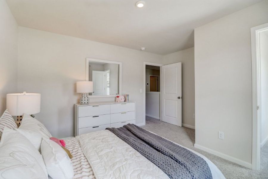 A bedroom with a bed and a mirror. A bedroom with a bed and a mirror.