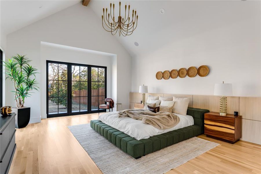 Bedroom featuring high vaulted ceiling, access to exterior, light hardwood / wood-style floors, and beam ceiling