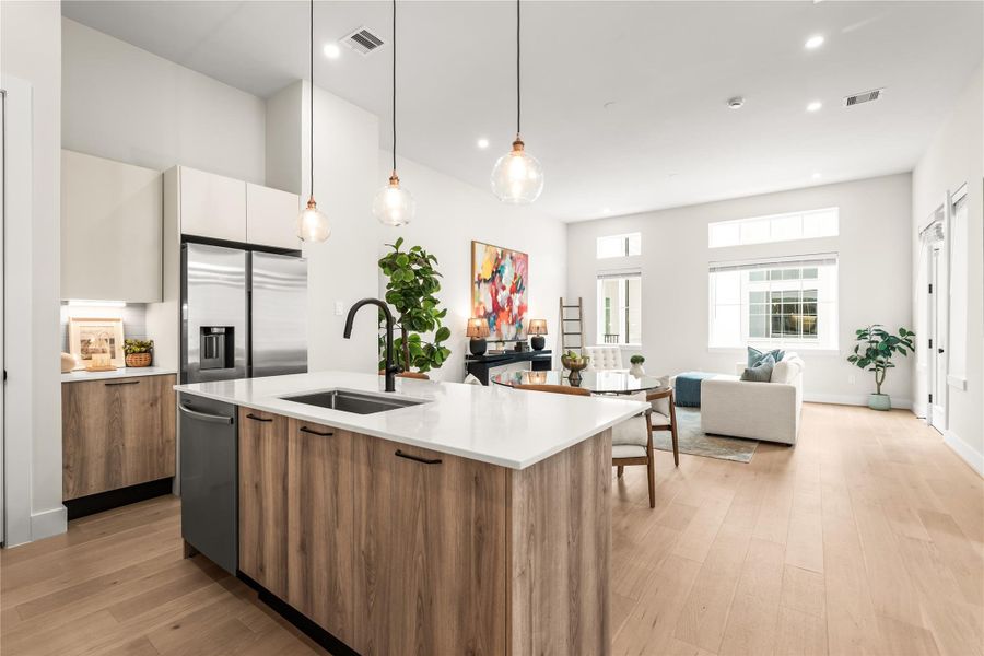 From the kitchen, the main level opens directly into dining and living areas, allowing each space to remain distinct without being closed off.