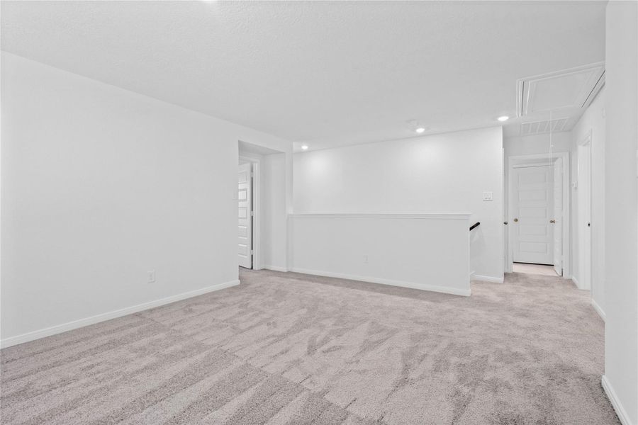 Additional view from the Loft looking towards staircase, entrance to primary suite on the left, and secondary bedrooms and bathroom to the right. Additional view from the Loft looking towards staircase, entrance to primary suite on the left, and secondary bedrooms and bathroom to the right.