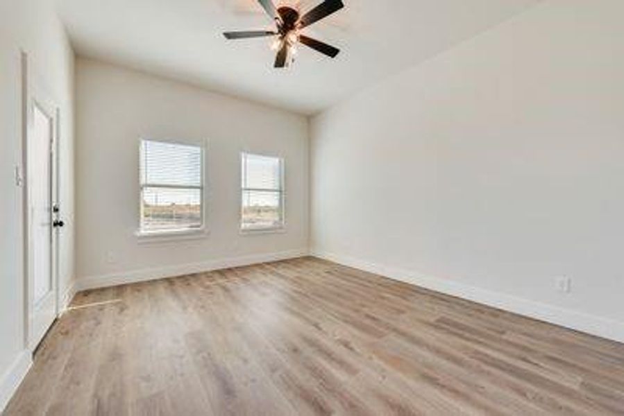 Spare room with light wood-type flooring and ceiling fan