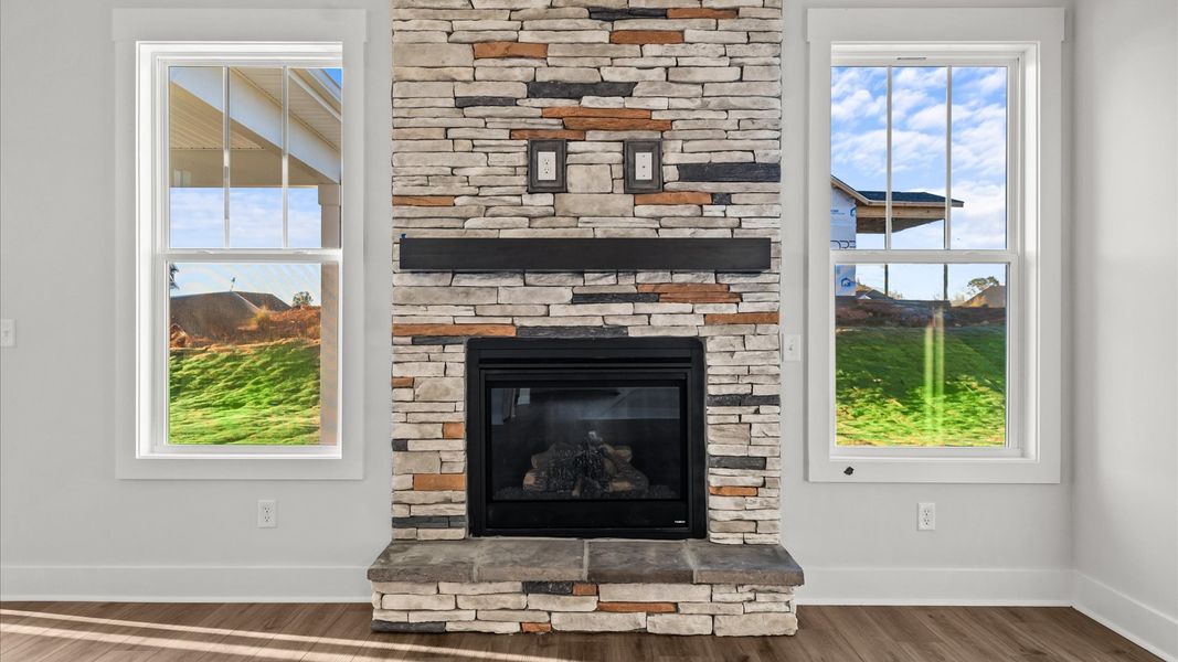 Elegant family room with soaring two-story ceilings and abundant natural light in this first-class DRB Homes design