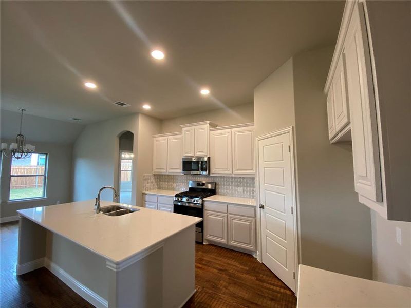 Kitchen has GE stainless gas appliances.