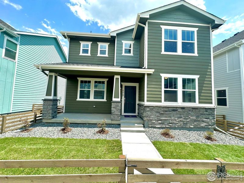 Front exterior of a new home in Waterfield, Fort Collins, CO, highlighting curb appeal (Image 26). Front exterior of a new home in Waterfield, Fort Collins, CO, highlighting curb appeal (Image 26).