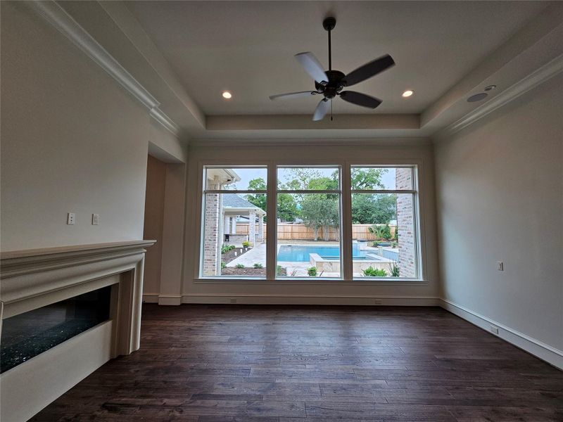 Photo Update April 2026 - Primary Bedroom with pool views and a 2-sided fireplace