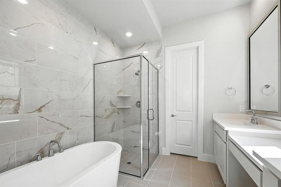 Full bathroom with double vanity, a freestanding bath, light tile patterned floors, a stall shower, and recessed lighting Full bathroom with double vanity, a freestanding bath, light tile patterned floors, a stall shower, and recessed lighting