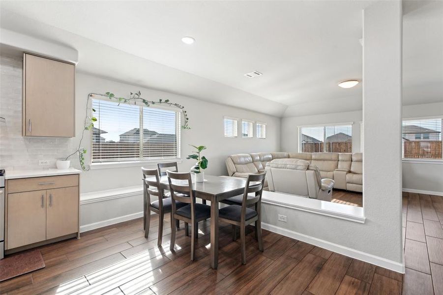 Dining space with dark hardwood / wood-style flooring