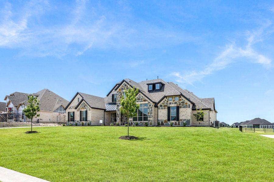 Front exterior of a new home in Heritage, McLendon-Chisholm, TX, highlighting curb appeal (Image 15).