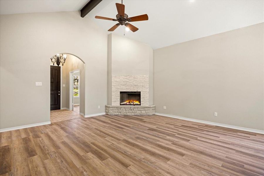 Unfurnished living room with arched walkways, light wood-style flooring, a ceiling fan, and a  4403 N. Port Ridglea Ct. Granbury,TX 76049