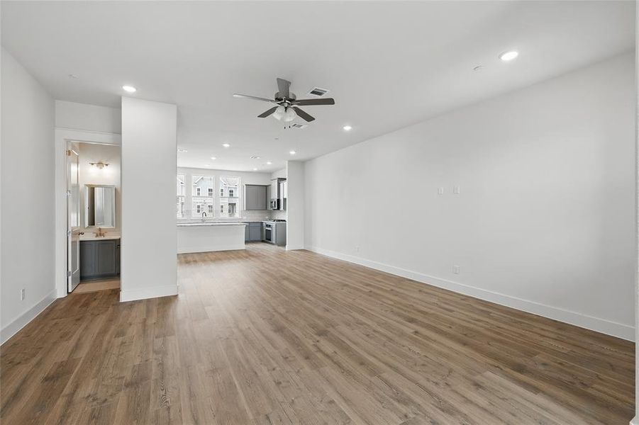 Unfurnished living room with a ceiling fan, light wood-style flooring, and recessed lighting