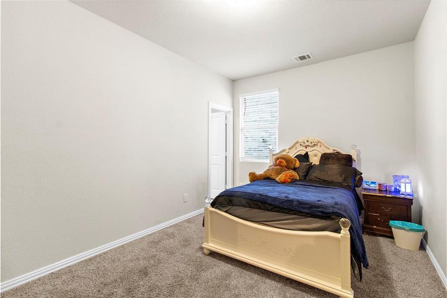 Carpeted bedroom featuring baseboards Carpeted bedroom featuring baseboards